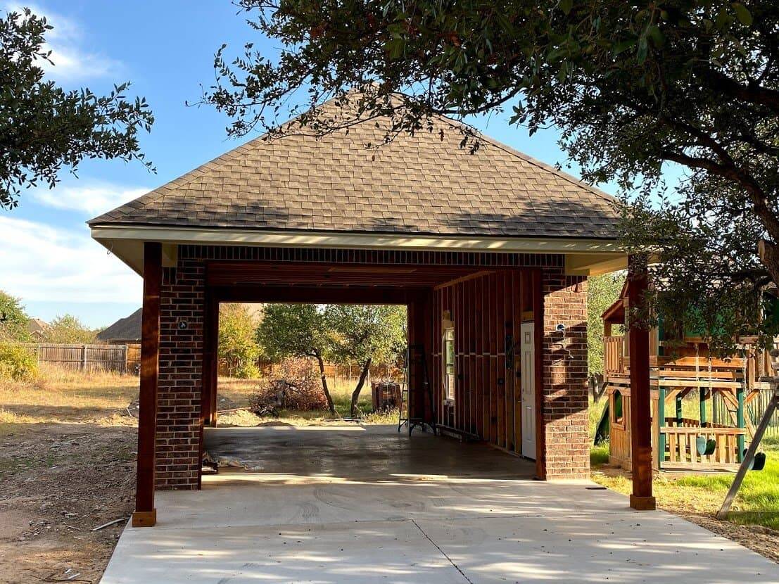 Hip-roof carport with brick columns and wood posts